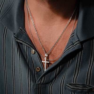 Sterling silver cross pendant worn by man with two chains